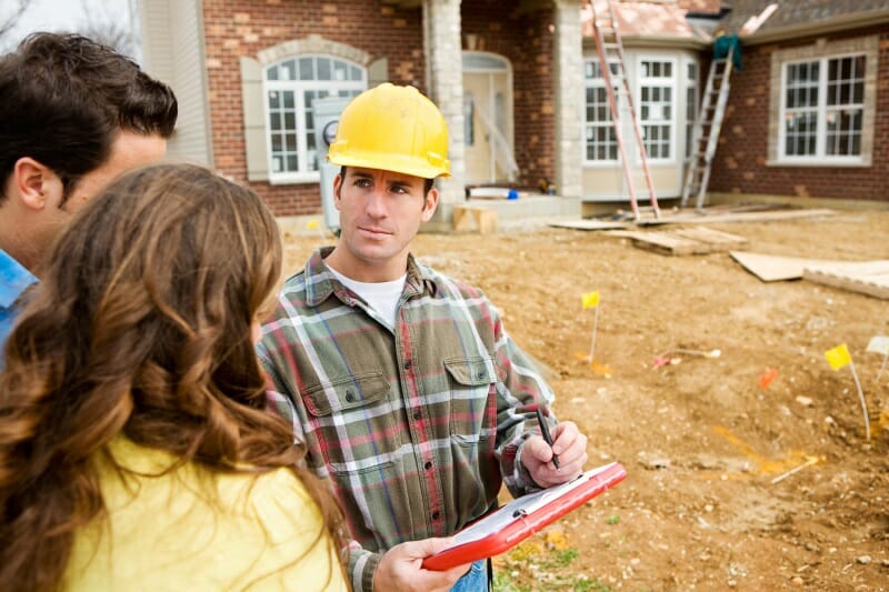 Client consulting with a roof leak repair technician.